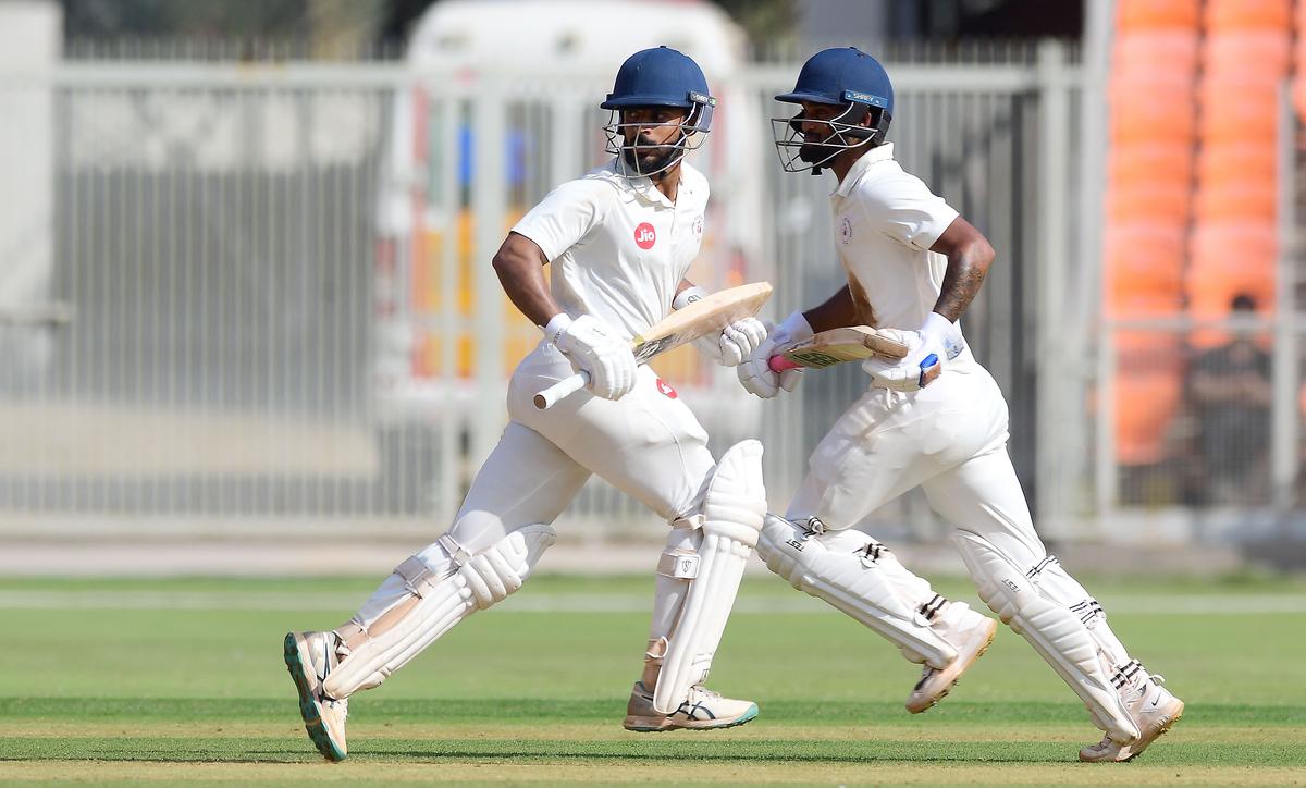 Kshitij Patel and Umang Kumar running between the wicket during the 1st day of Ranji Trophy match between Gujarat and Karnataka.