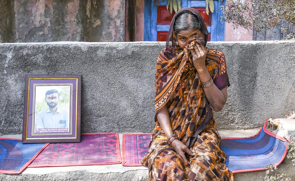 Inconsolable: Sunitha Kalyan Phatangade with a portrait of her son, Umesh, who died by suicide on July 31 last year, at Murmagaon in Chhatrapati Sambhajinagar.
