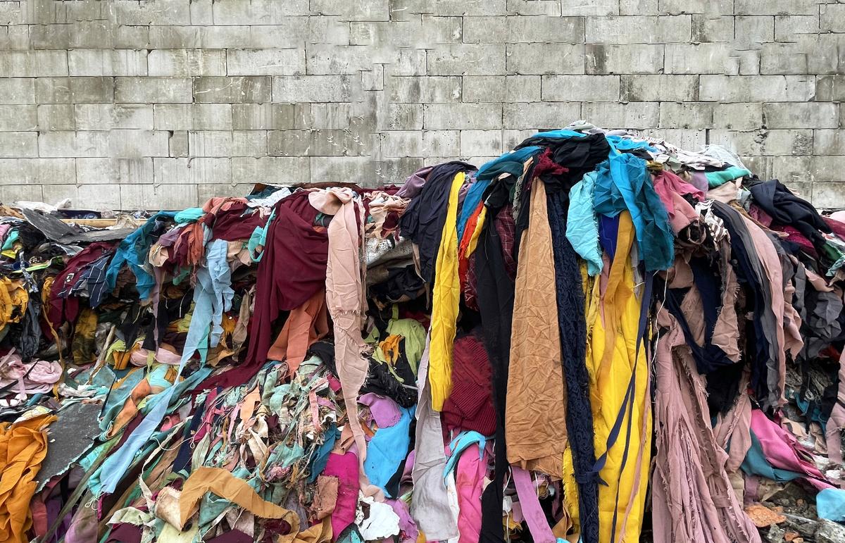 Fast fashion waste at landfill Fast fashion waste at landfill