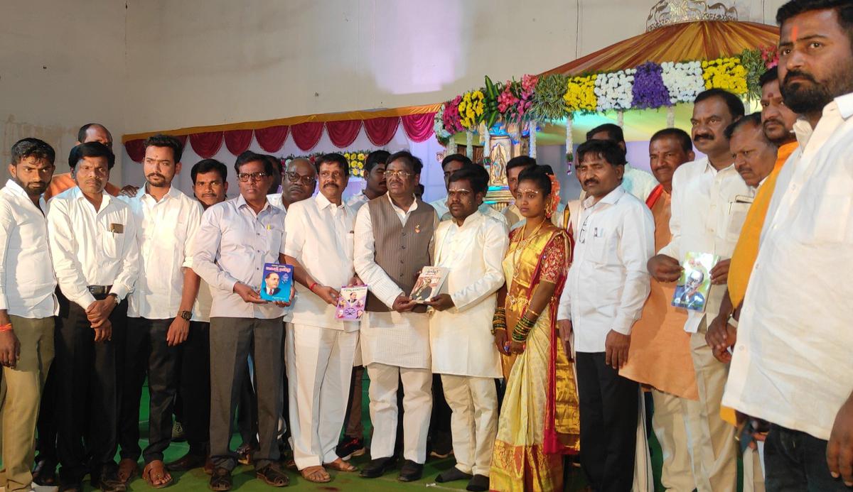 Guests gifting books to the newlyweds.