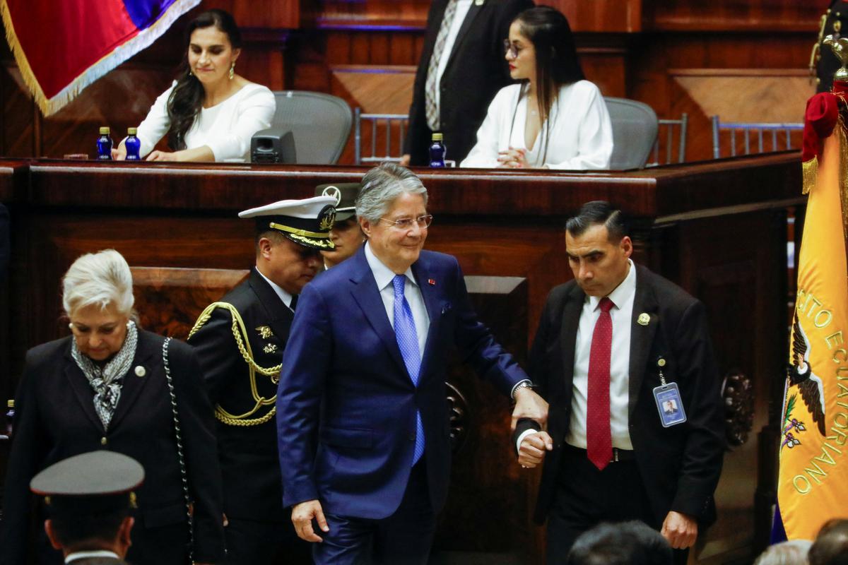 Ecuador’s former President Guillermo Lasso walks off stage during President Daniel Noboa’s swearing-in ceremony at the National Assembly, in Quito.