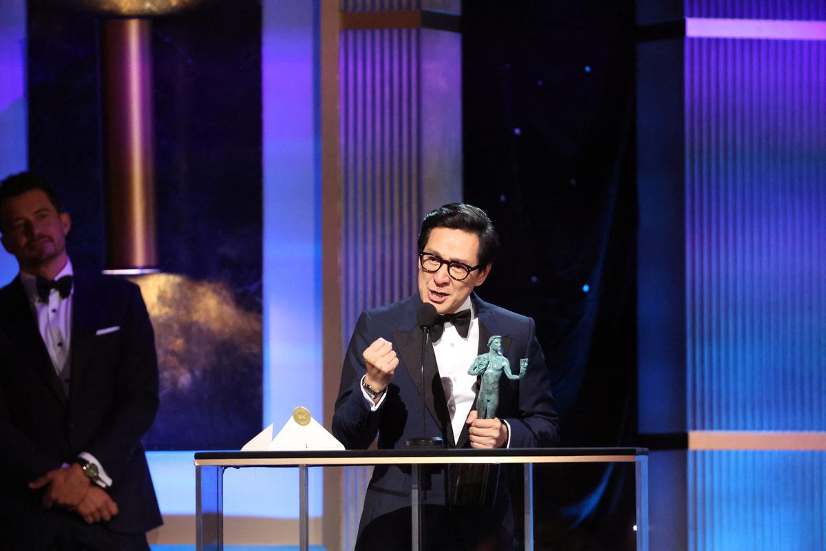 Ke Huy Quan accepts the Outstanding Performance by a Male Actor in a Supporting Role award for ‘Everything Everywhere All at Once’  during the 29th Screen Actors Guild Awards.