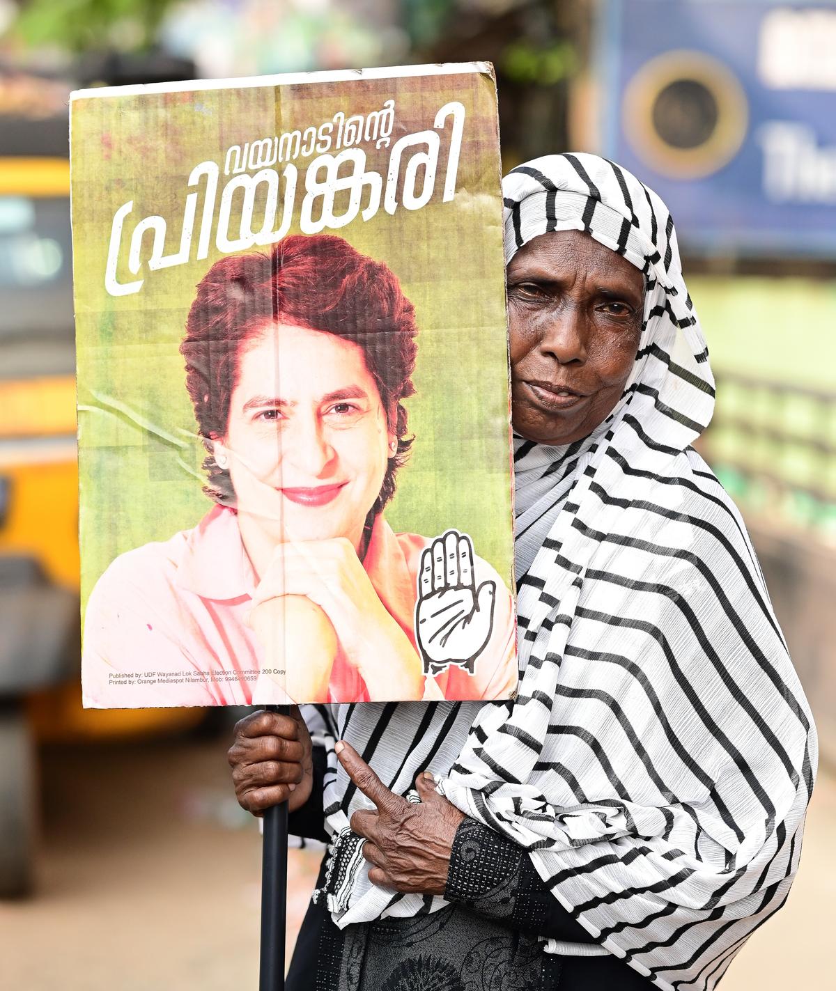 An elderly woman holding Priyanka Gandhi’s poster waiting for her arrival at Edavanna on Tuesday.