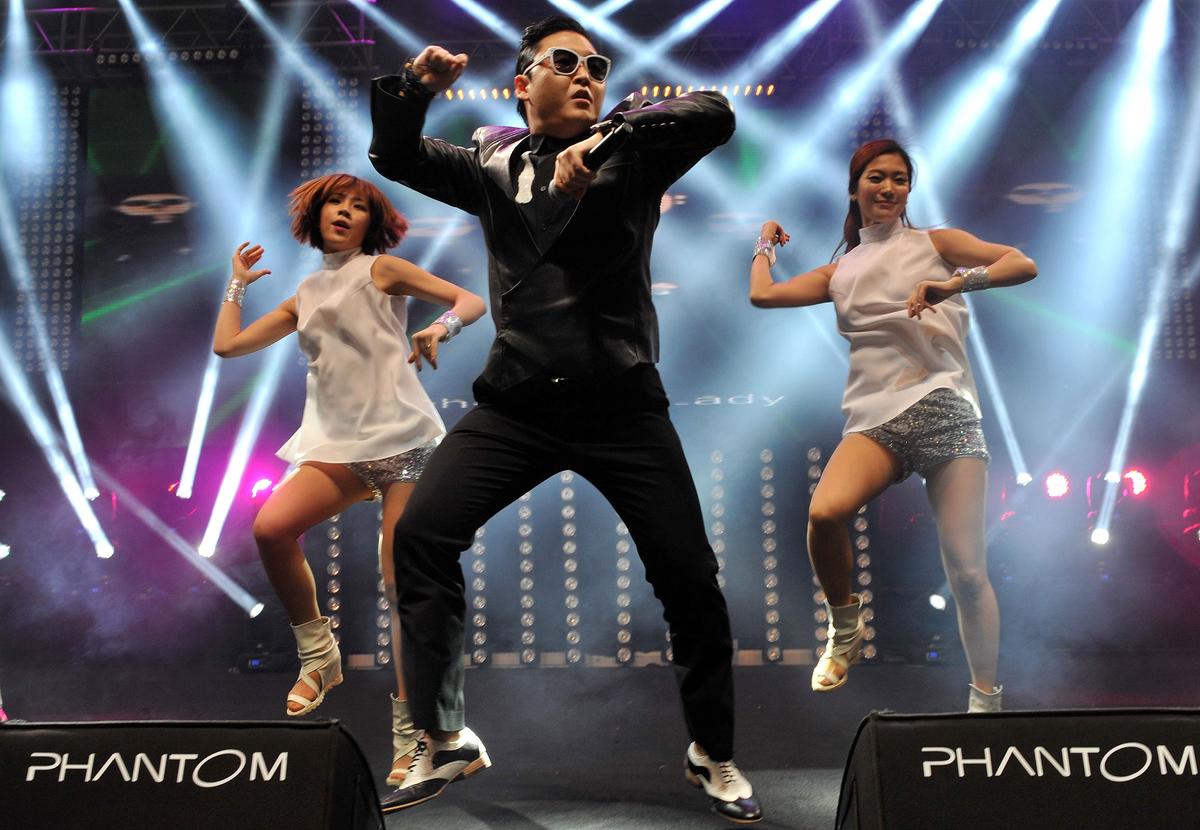 South Korean singer Psy (L) performs his hit single “Gangnam Style” during a concert in Istanbul as part of the Istanbul Blue Night festival.