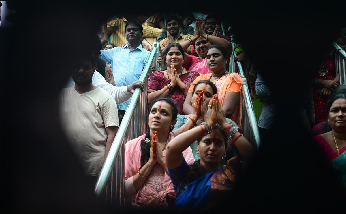 Devotees standing in a queue line waiting for glimpse of presiding deity goddess Kanaka Durga atop Indrakeeladri in Vijayawada on Friday