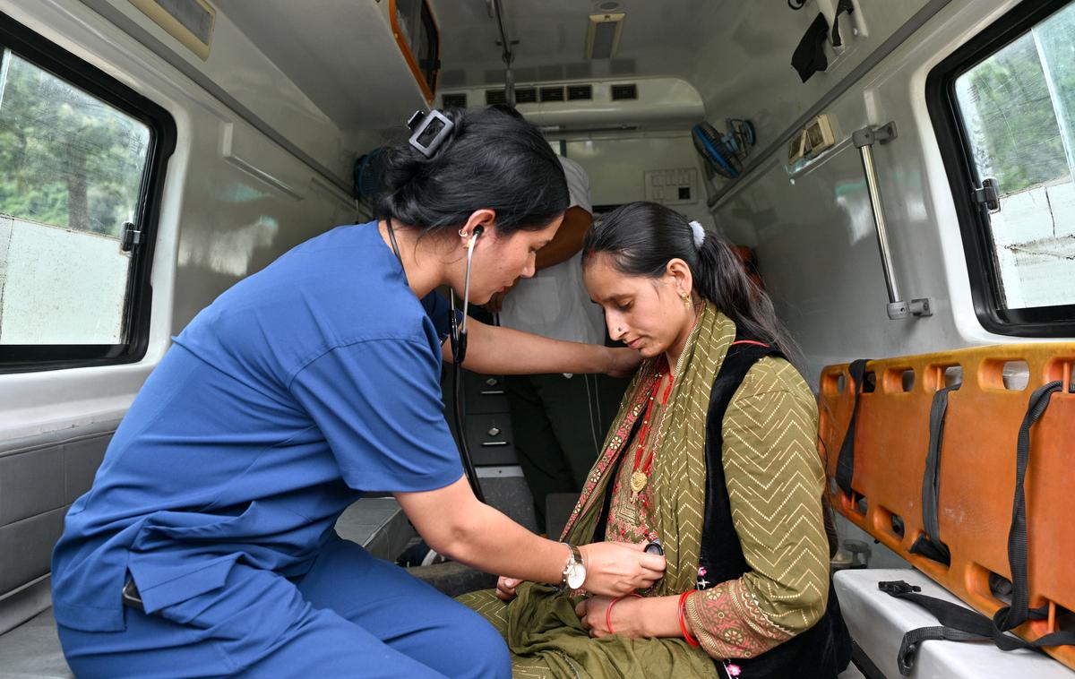 A pregnant woman who was rescued from  Dharali village being checked by doctors inside an ambulance at the Matli helipad in Uttarkashi.