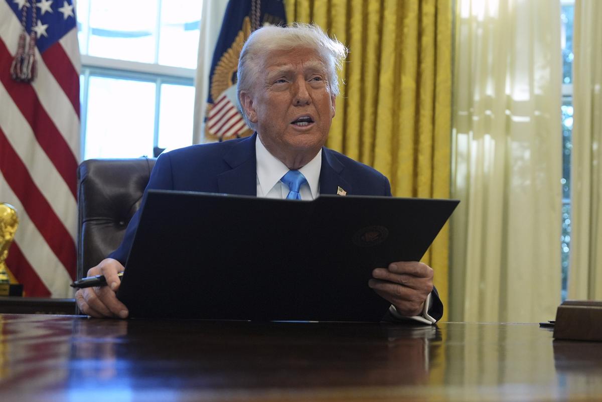 President Donald Trump speaks to reporters as he signs a executive order in the Oval Office of the White House, on February 4, 2025, in Washington.