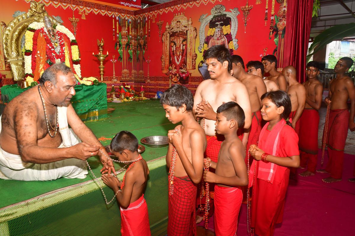 Devotees in red robes throng Kanaka Durga temple in Vijayawada to take Bhavani Deeksha