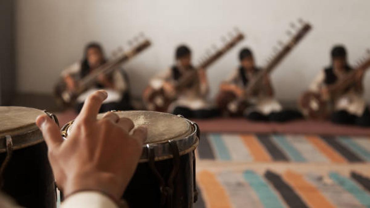 A band of high school musicians playing the sitar.