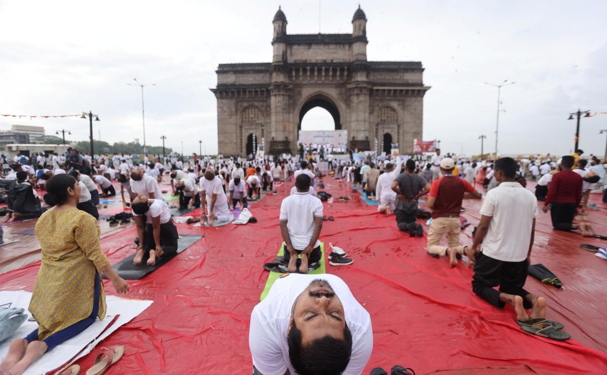 People perform yoga in front of the Gateway of India, during International Yoga Day in Mumbai, India, on June 21, 2022.