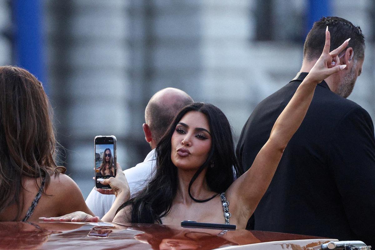 Kim Kardashian gestures on a boat, ahead of Jeff Bezos and Lauren Sanchez in Venice, Italy