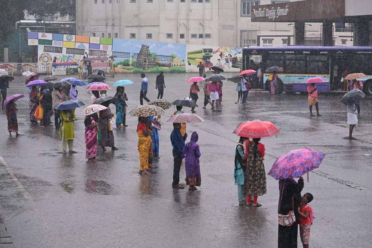 Commuters waiting for bus at Periyar bus stand on October 21, 2025 when Madurai experienced heavy downpour