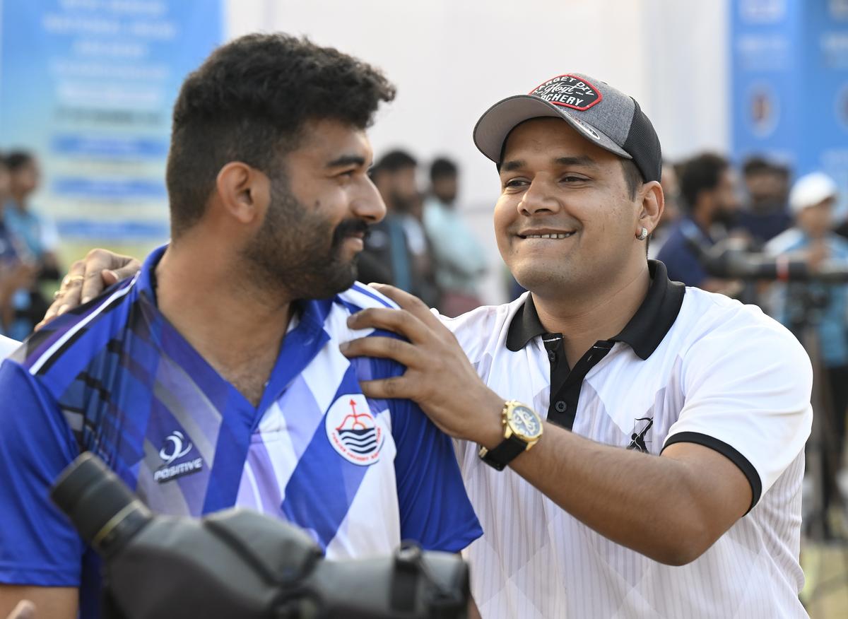 Abhishek  Verma of Delhi, right, in a lighter  moment after beating Uday Kamboj of Punjab in compound men’s final at the   44th National Archery Championship at Jamshedpur on Thursday, December 19, 2024.