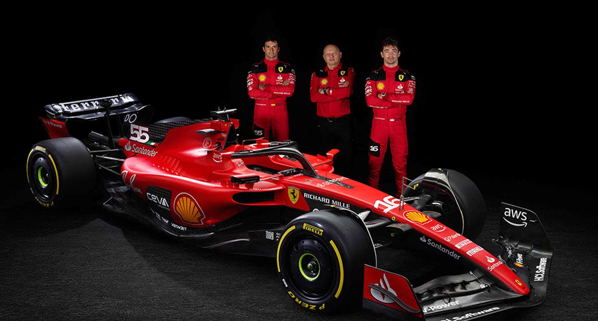 This handout photograph made available on February 14, 2023, by Scuderia Ferrari, shows (from left) Ferrari’s Spanish Formula One driver Carlos Sainz Jr, newly-named Ferrari Formula One team principal, Frederic Vasseur, and Ferrari’s Monegasque driver Charles Leclerc posing by Ferrari’s new single-seater SF-23 for the 2023 season. - Ferrari unveiled its new single-seater in its Italian home of Maranello on February 14, 2023, with the ambition of catching up with Red Bull after a 2022 season marked by costly race strategy errors and engine failures. 