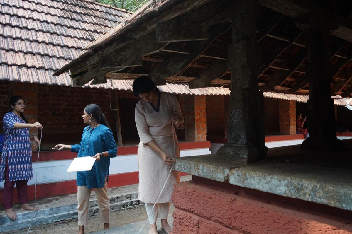The architects at work on the Karnikara mandapam of  Kunnamangalam Bhagawati Temple in Naduvannur in Kozhikode district. 