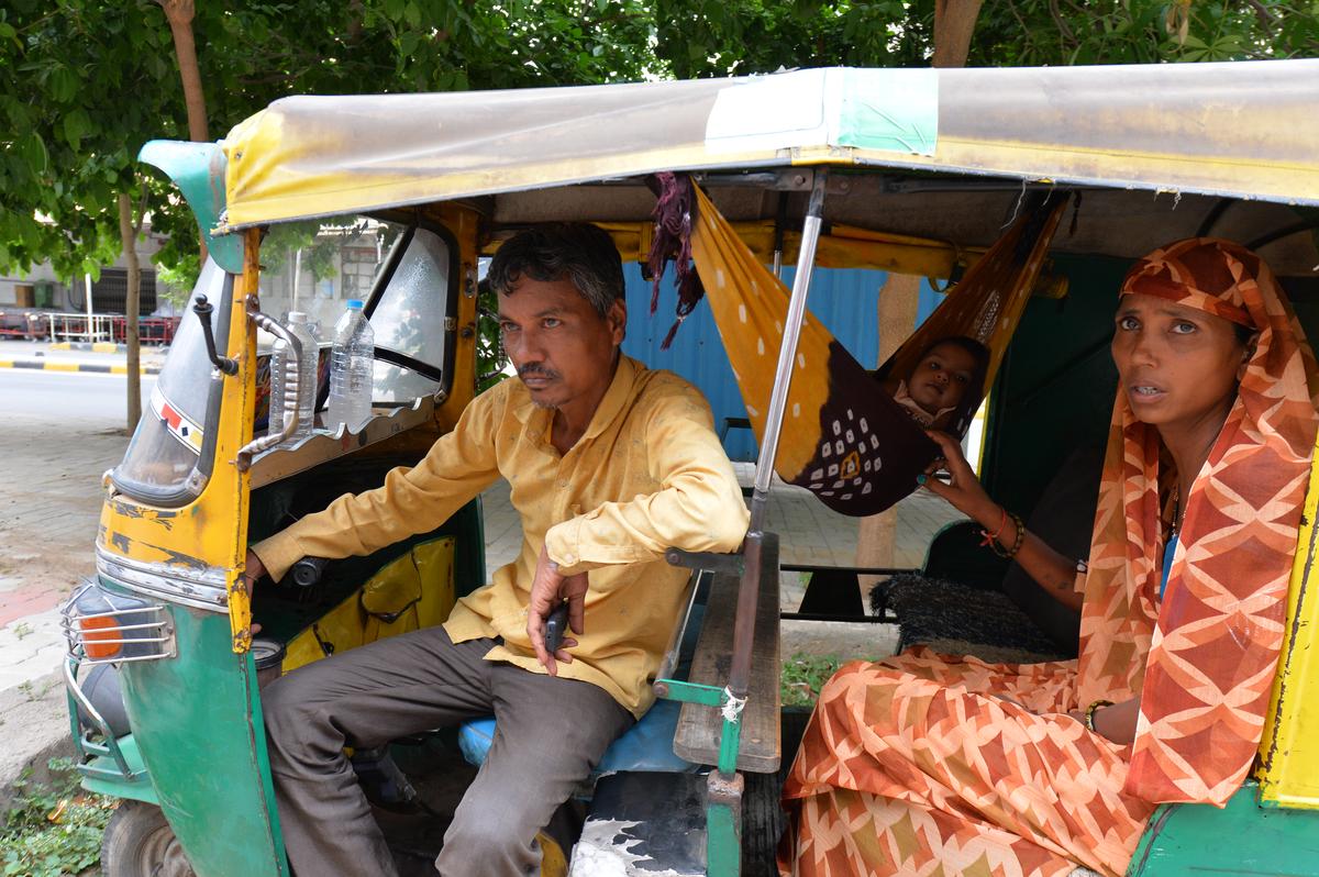 Surajbhai Patani, an autorickshaw driver from Ahmedabad, waits outside the morgue to collect his 15-year-old son’s mortal remains. 
