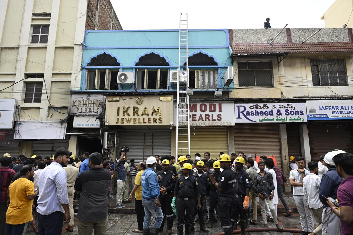 Panic stricken people after a fire broke out in a building near Gulzar Houz in the Old City area of Hyderabad.