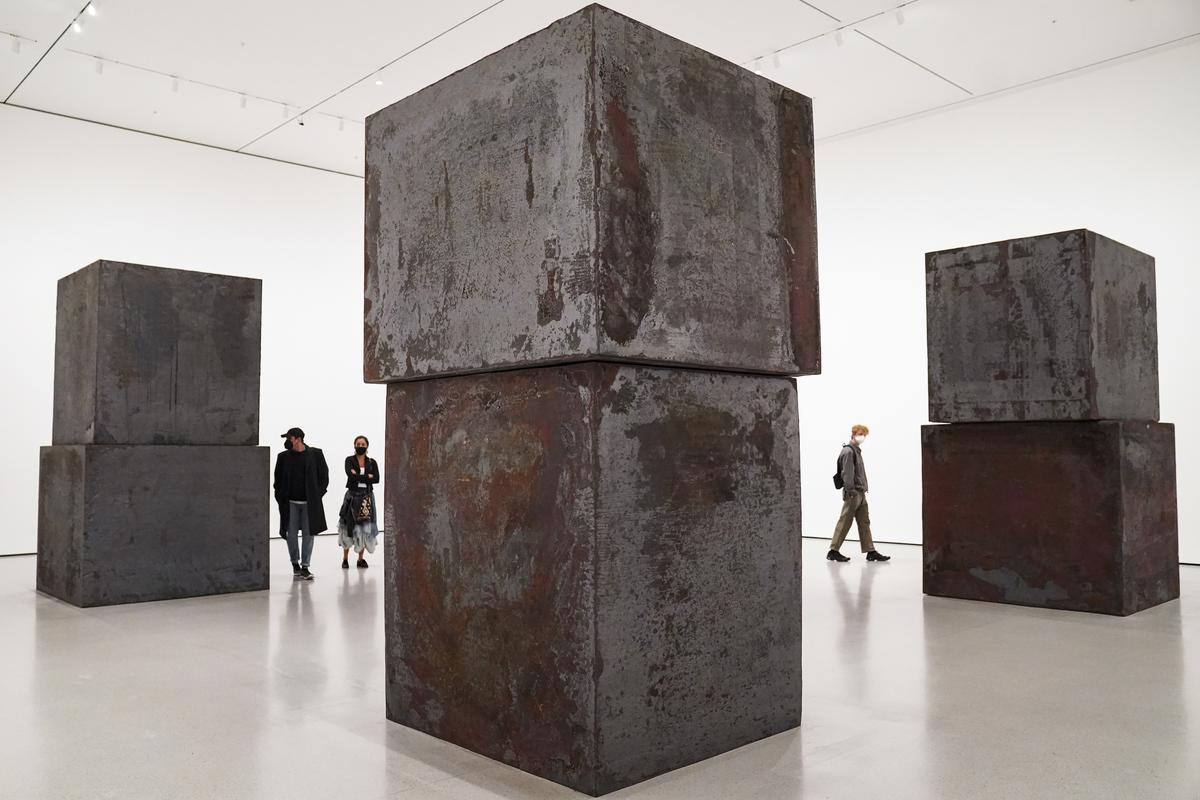Guests browse Richard Serra’s “Equal” at the Museum of Modern Art in the new fall exhibition spaces, Nov. 13, 2020, in New York. 