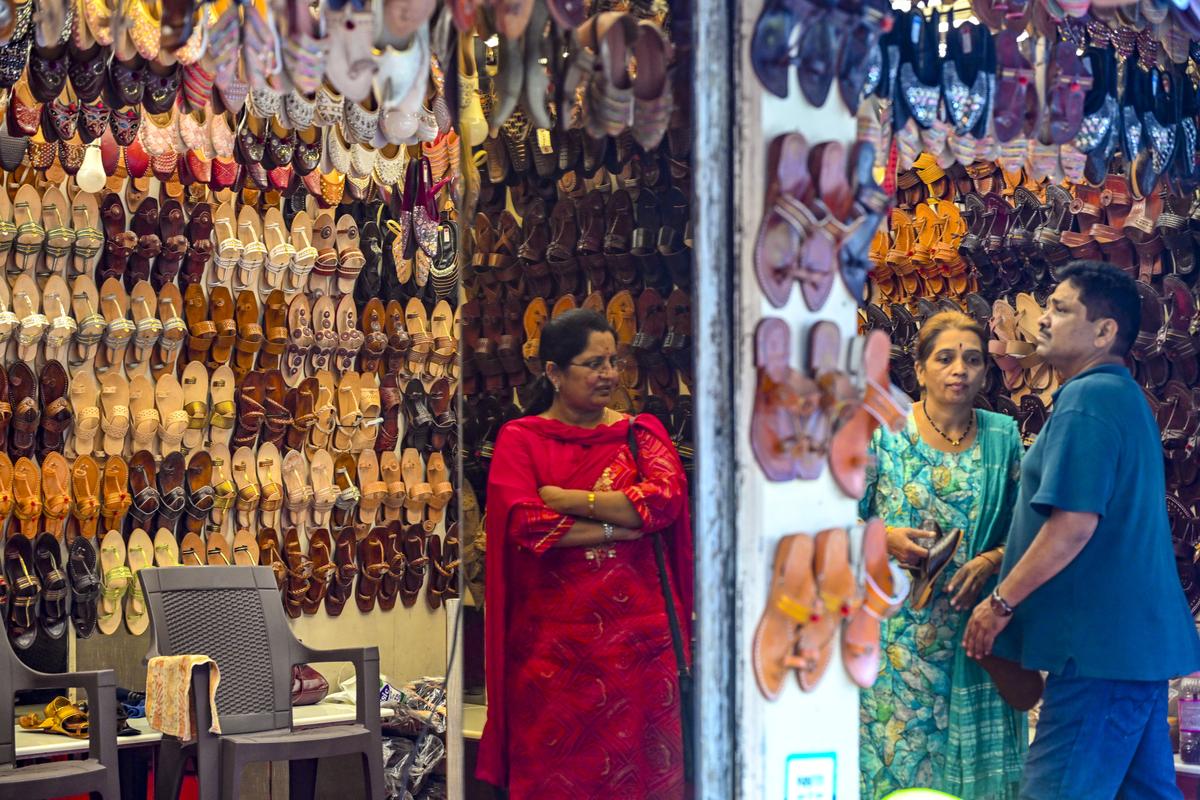 Visitors shop Kolhapuri Chappals  inside a store in Chappal market in Kolhapur. 