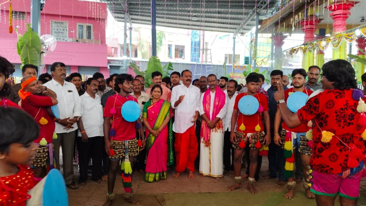 Devotees and folk artists beating drums at Thathayagunta Gangamma temple in Tirupati on Monday.
