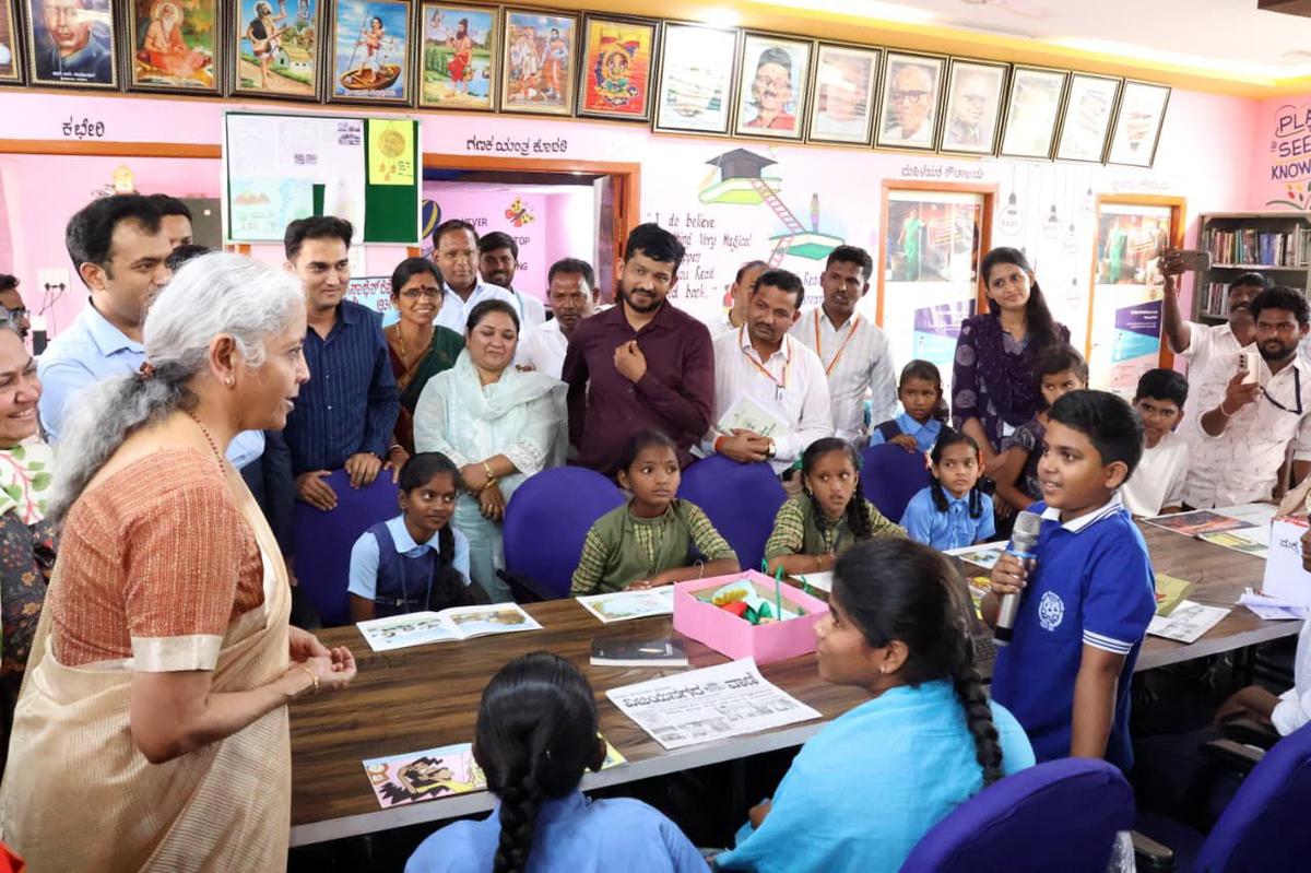 Union Finance Minister Nirmala Sitharaman interacting with students and teachers at a digital public library at Bagewadi village in Siruguppa taluk on Thursday.