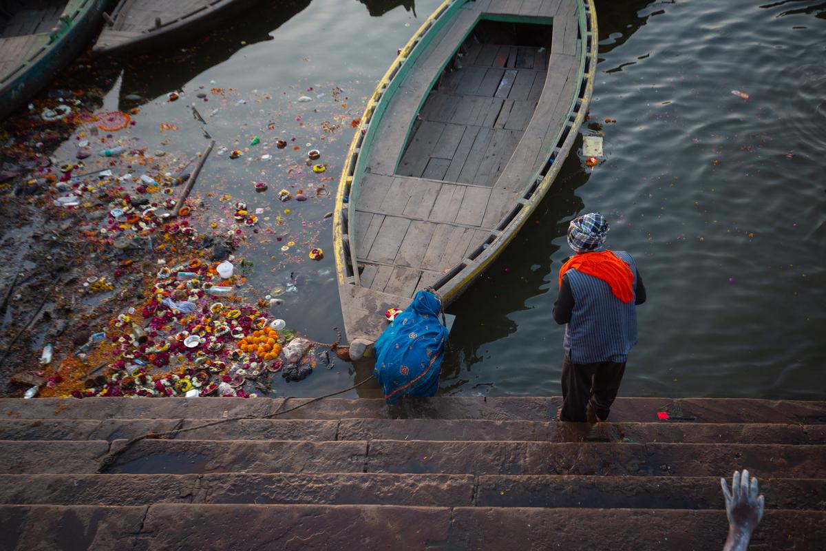Pilgrims offer prayers along the banks of the Ganges River strewn with flowers offered in religious rituals and plastic bottles at the break of dawn on March 04, 2025 in Varanasi. Pilgrims offer prayers along the banks of the Ganges River strewn with flowers offered in religious rituals and plastic bottles at the break of dawn on March 04, 2025 in Varanasi.