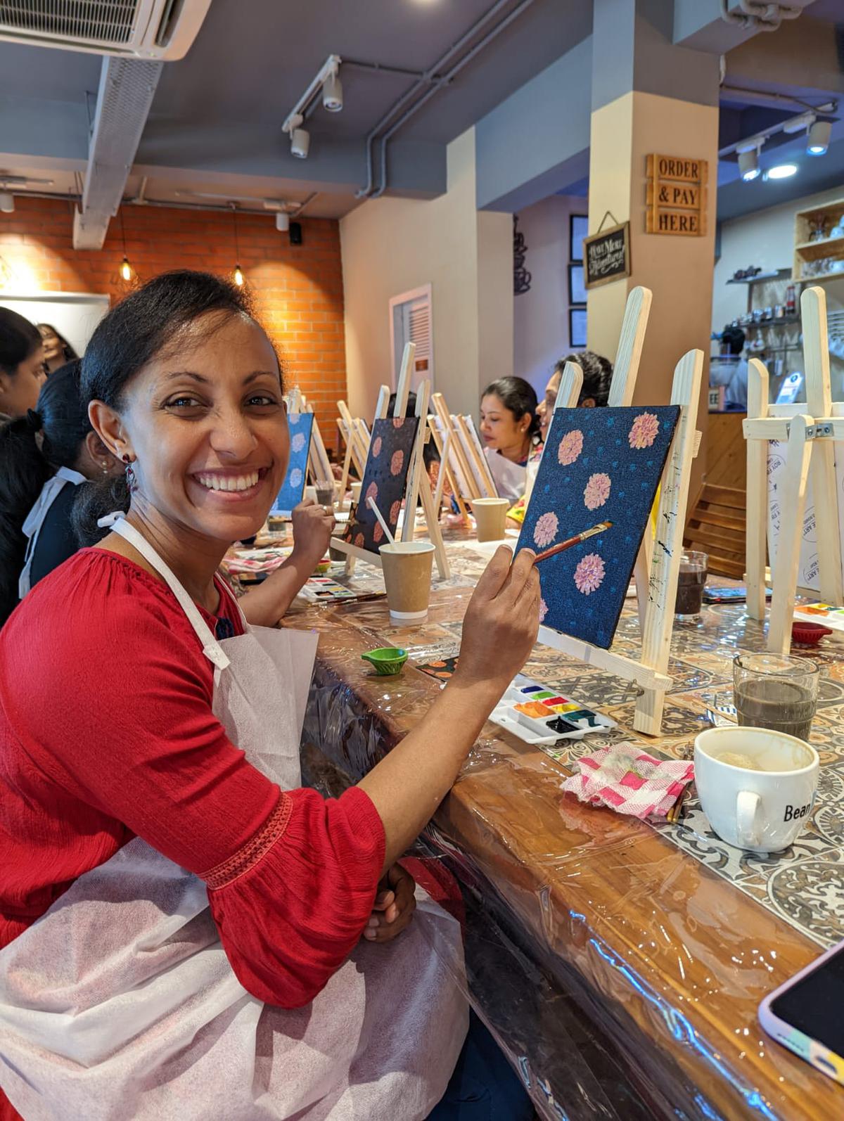 Participants take part in a sip and paint session at a cafe in Visakhapatnam.