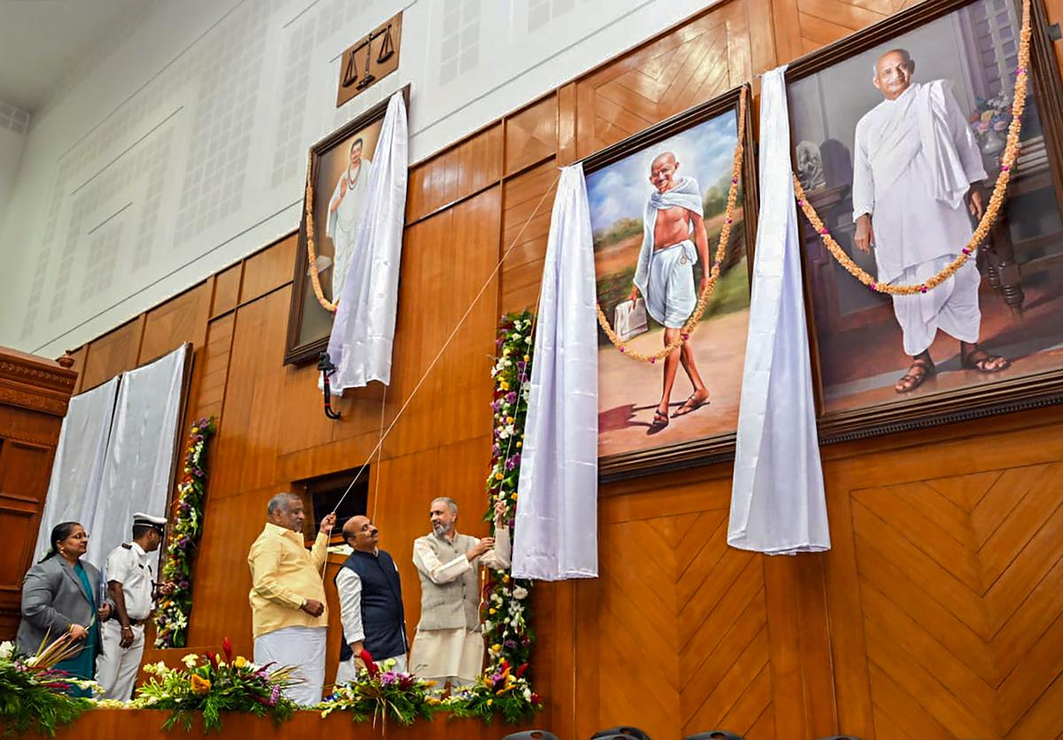 Karnataka Chief Minister Basavaraj Bommai and Assembly Speaker Vishweshwar Hegde Kageri unveil a portrait of Mahatma Gandhi on the first day of the winter session of the Karnataka Assembly, at Suvarna Vidhana Soudha in Belagavi on December 19, 2022. 