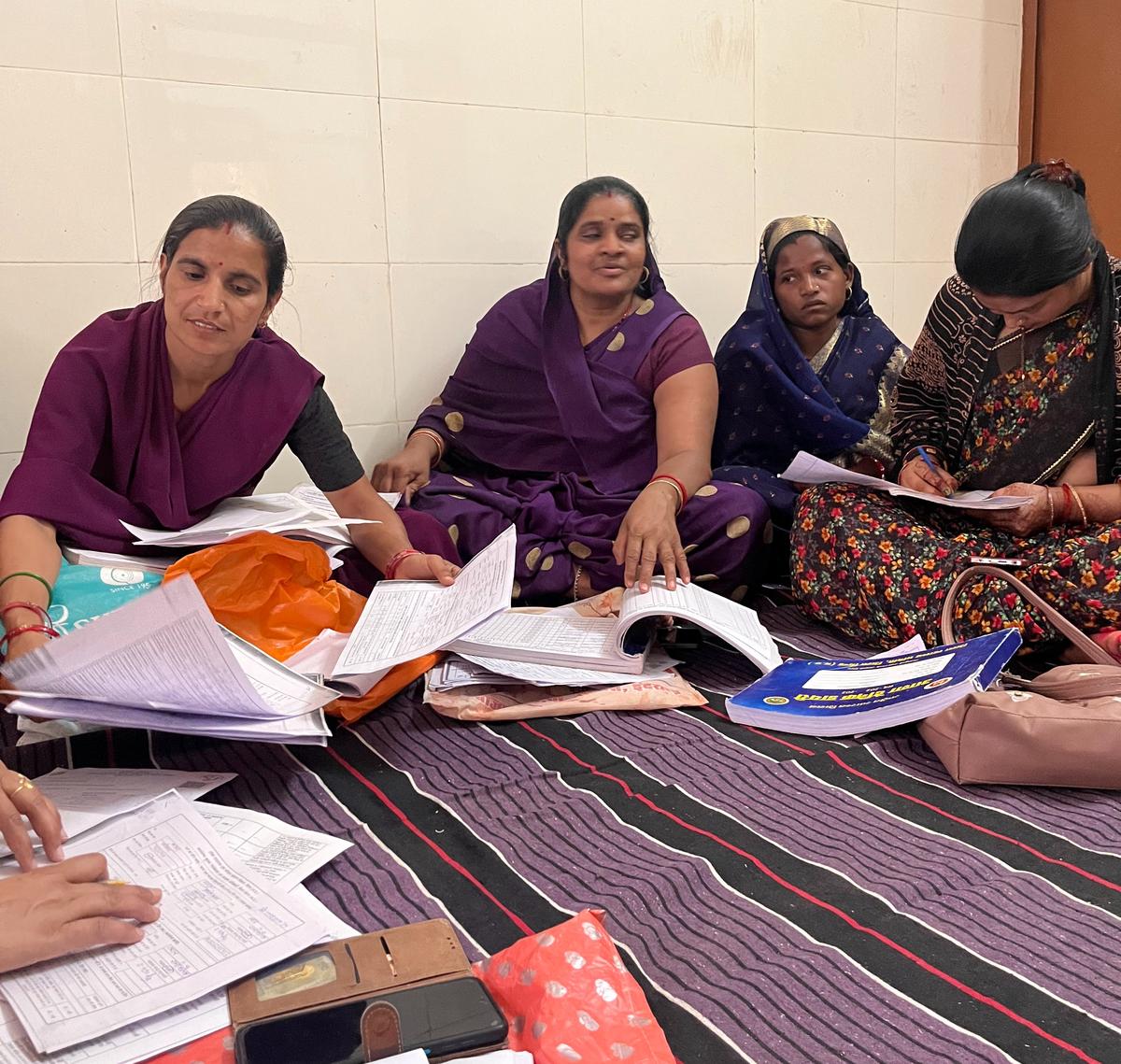 ASHA workers do paperwork in Dabho, Madhya Pradesh.
