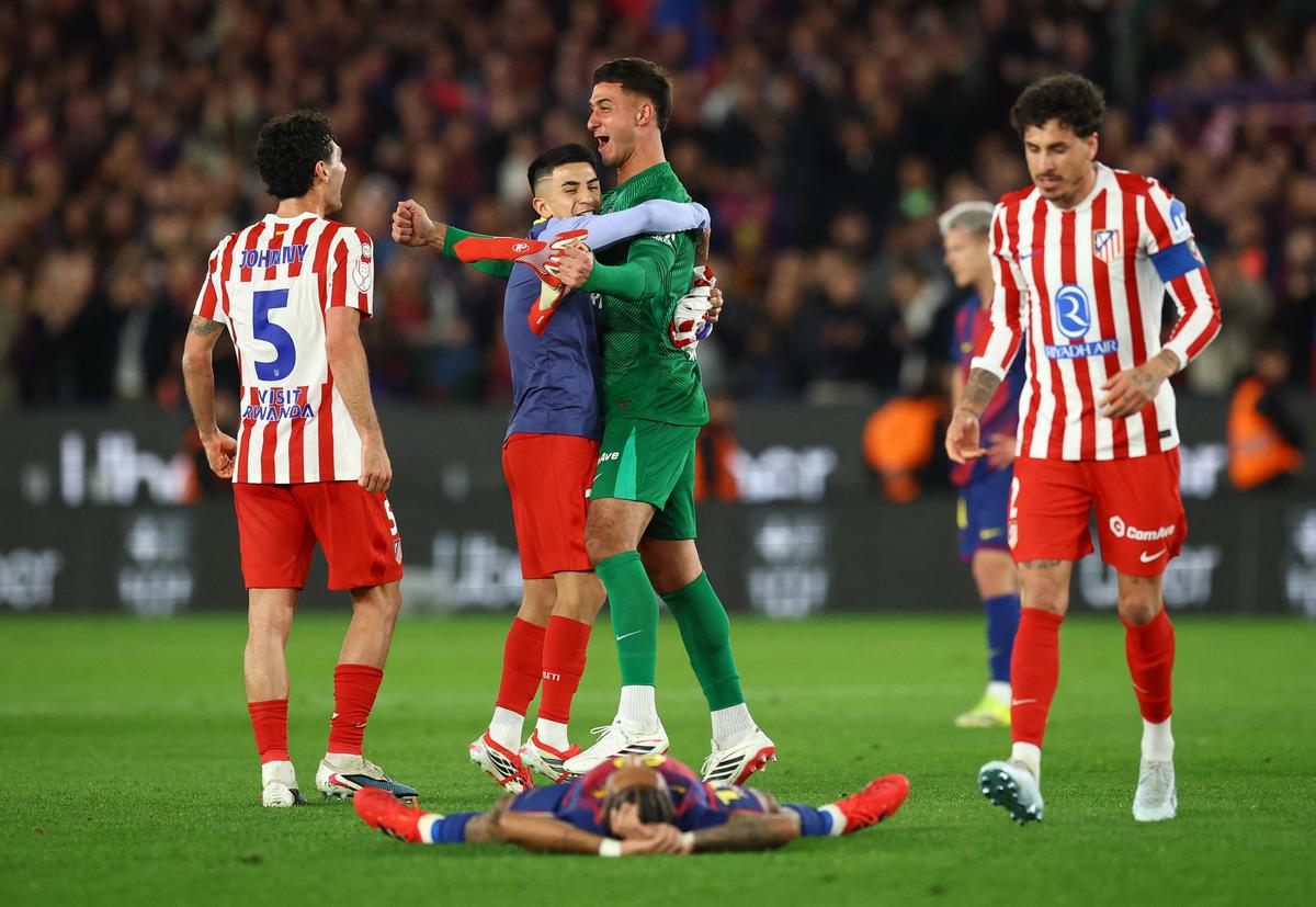 Atletico Madrid's Juan Musso, Johnny Cardoso, and teammates celebrate after the match
