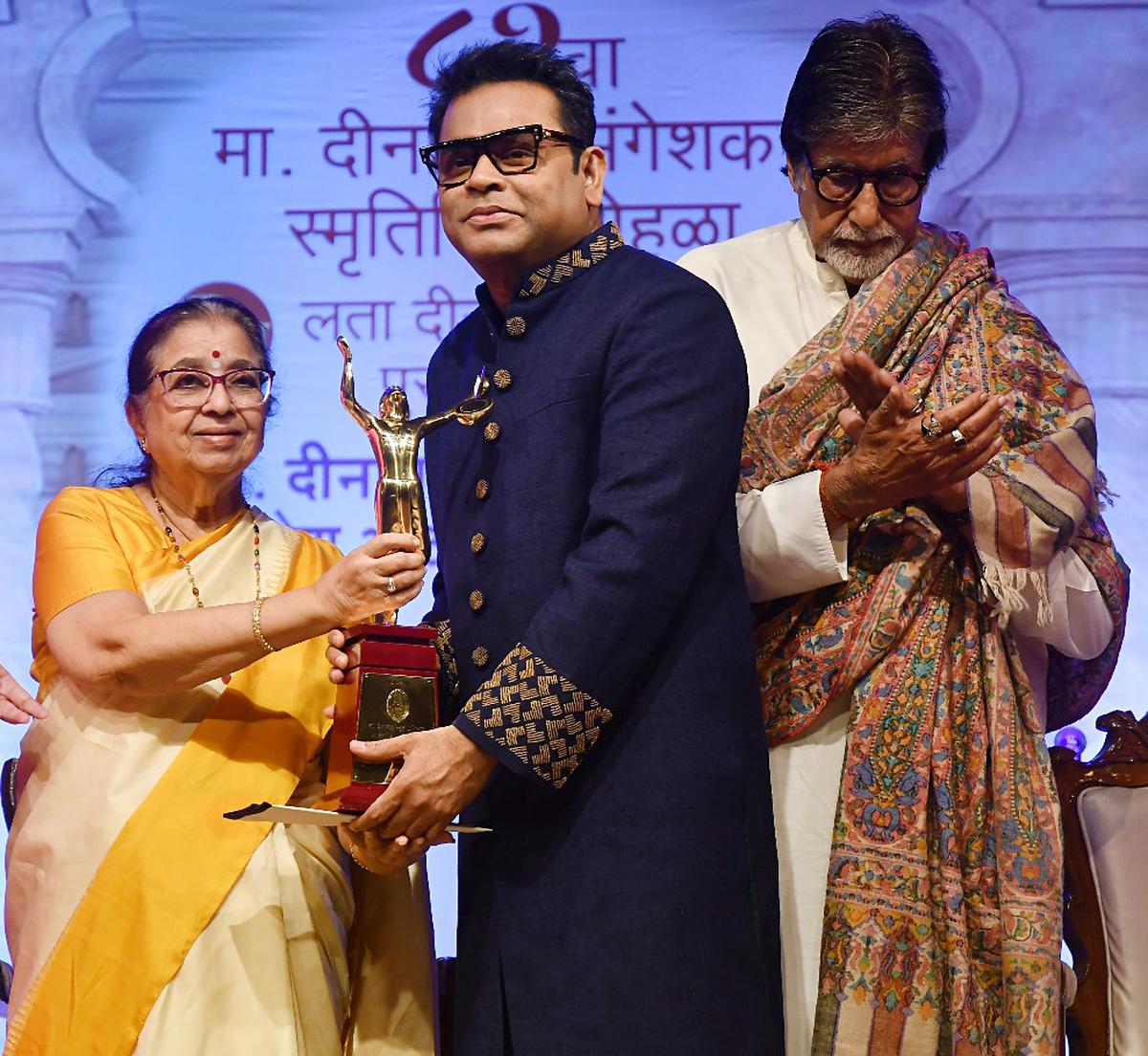 Music composer AR Rahman being conferred with the Lata Deenanath Mangeshkar Award by veteran singer Usha Mangeshkar during the Deenanath Mangeshkar Awards ceremony, in Mumbai on Wednesday. Actor Amitabh Bachchan are also seen.