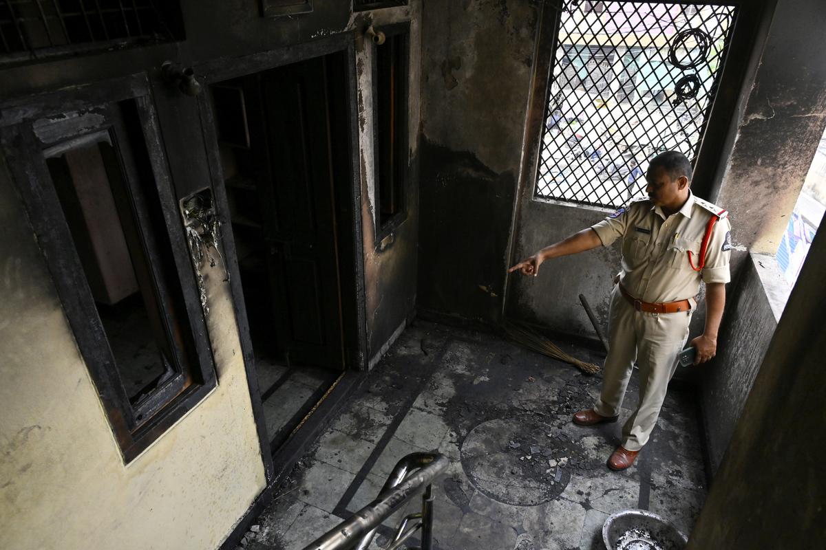 A policeman inspecting the spot where the fire took place late on Monday night.