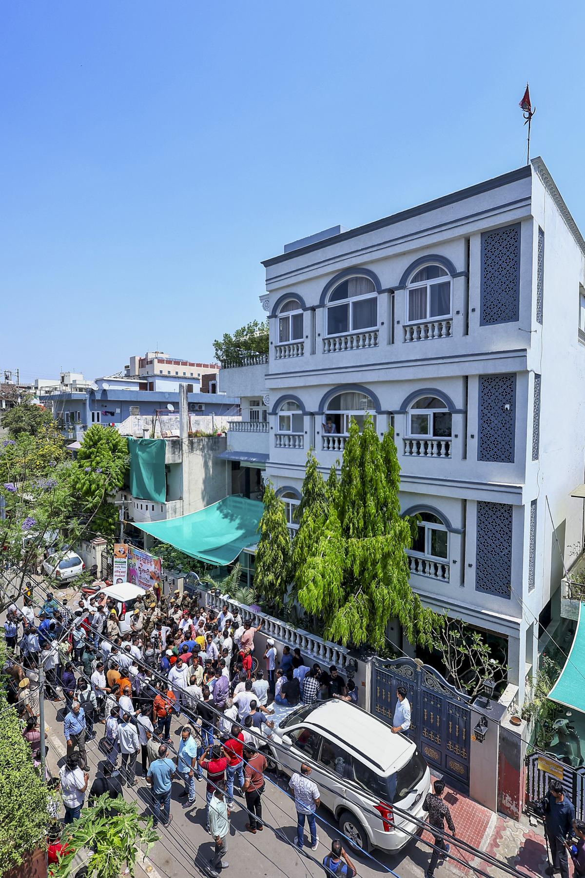 Supporters of Congress leader and former Minister Pratap Singh Khachariyawas assemble outside his residence in Jaipur on Tuesday, April 15, 2025, during the ED search.  