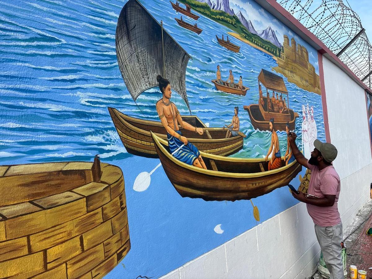 An artist working on the mural