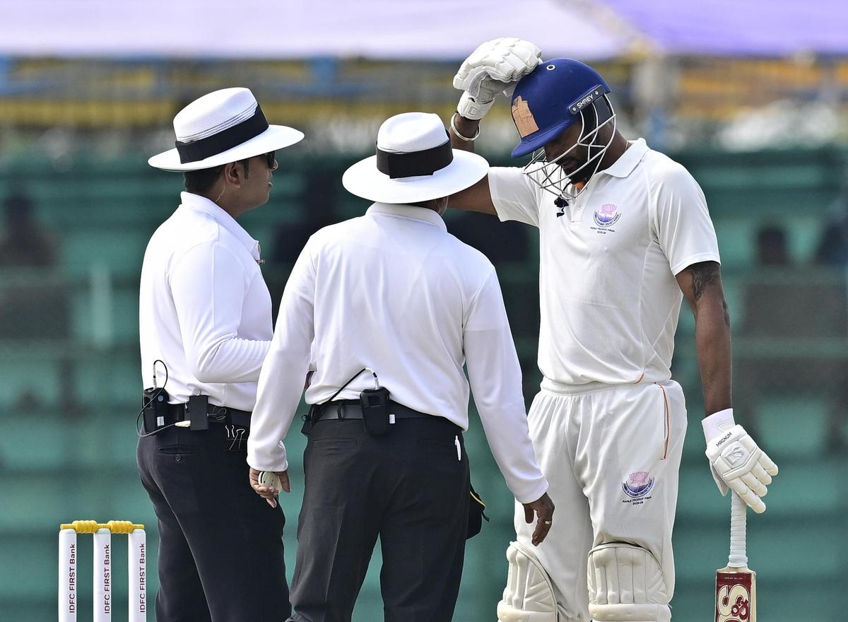 Jammu & Kashmir captain Paras Dogra interacts with the field umpires.