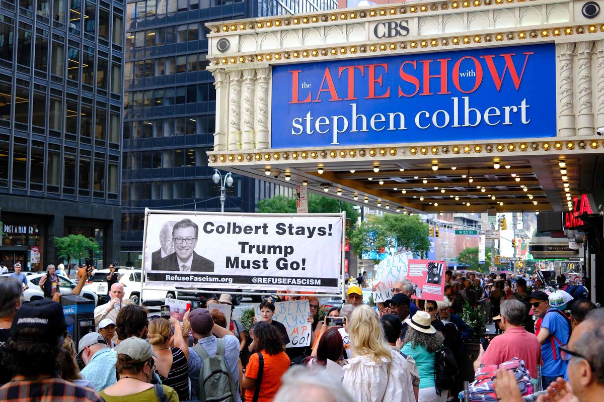 A person takes part in a protest after CBS/Paramount cancelled The Late Show with Stephen Colbert A person takes part in a protest after CBS/Paramount cancelled The Late Show with Stephen Colbert