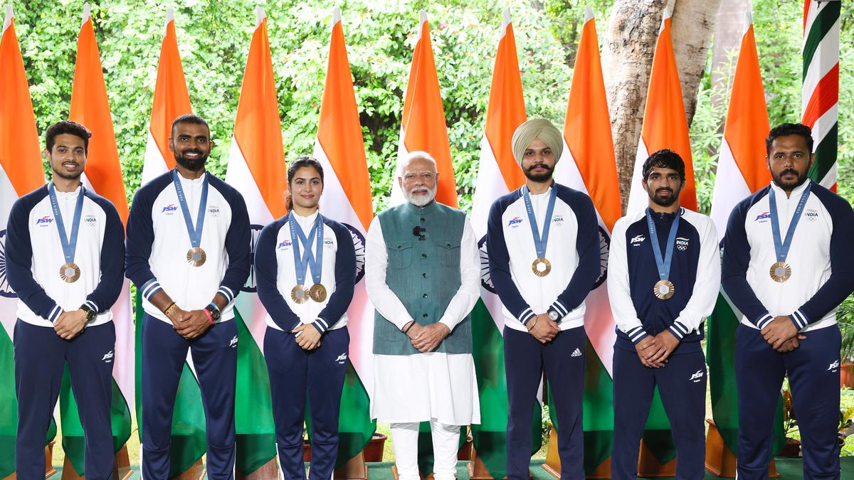 Bhaker explains about pistol, hockey team presents signed stick as PM meets Olympics contingent