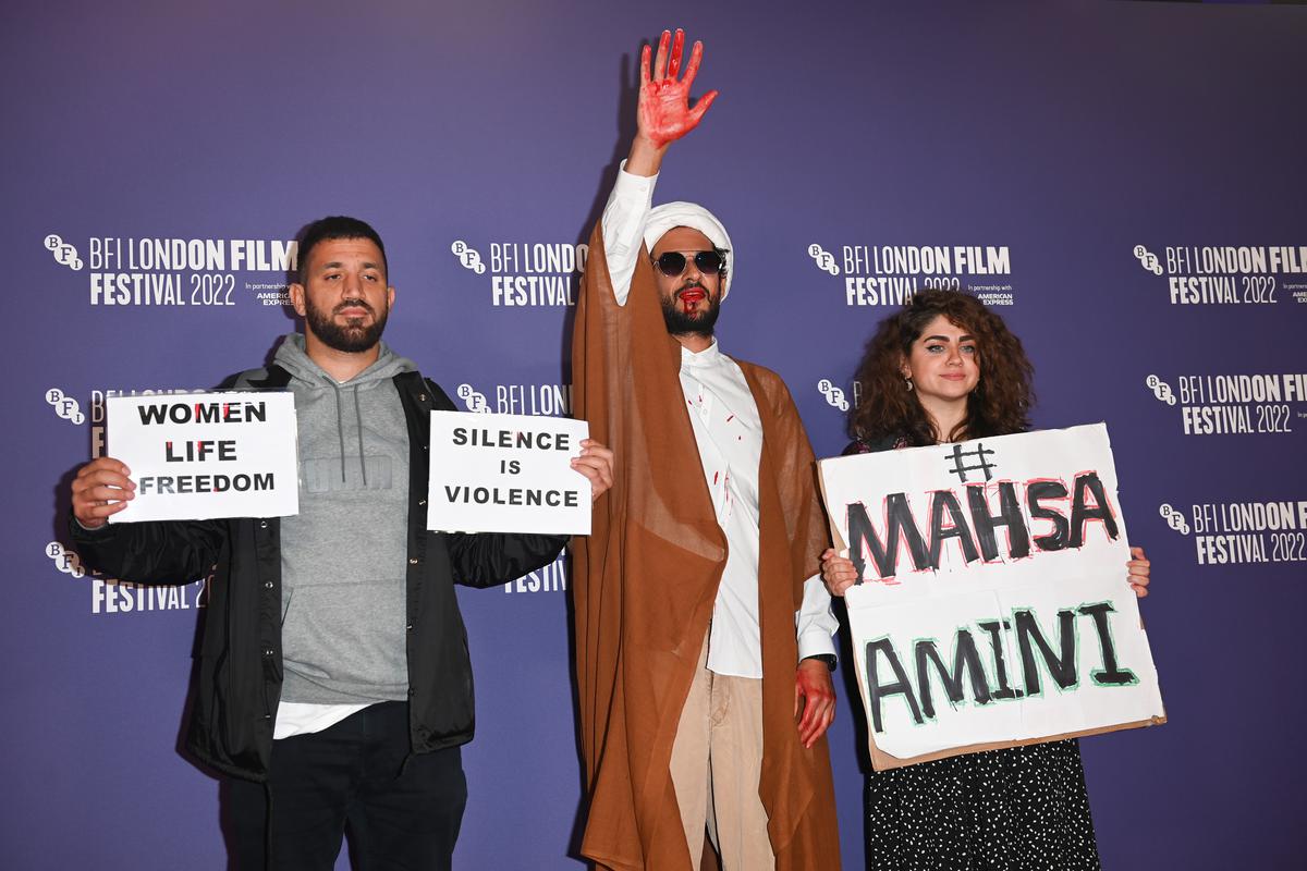 Iranian filmmaker Ali Abbasi (centre) with protesters at the premiere of his film ‘Holy Spider’ at BFI London Film Festival on October 8, 2022. 