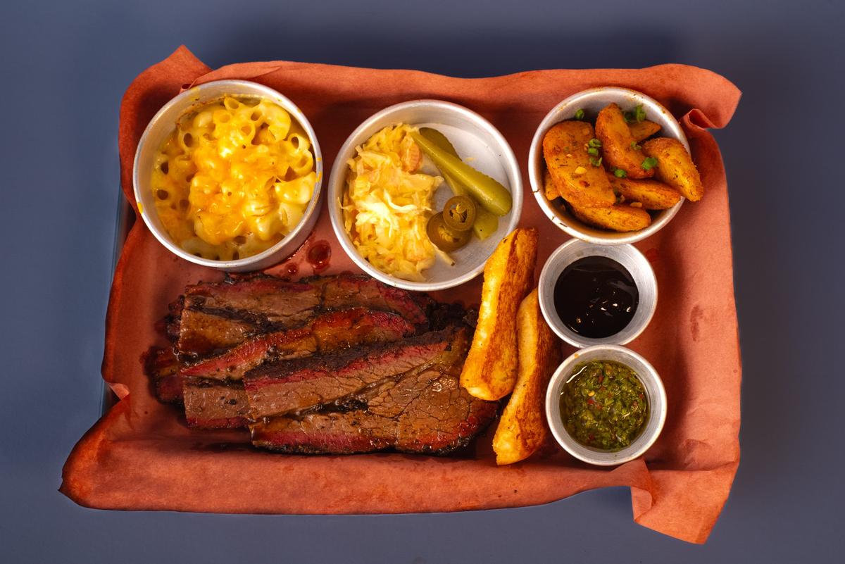 Beef brisket with barbeque sauce, chimichurri sauce, mac and cheese, coleslaw, potato wedges and bread Beef brisket with barbeque sauce, chimichurri sauce, mac and cheese, coleslaw, potato wedges and bread