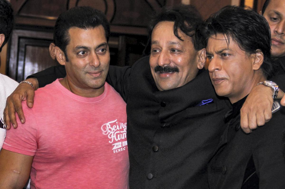 Baba Siddique with actors Salman Khan and Shah Rukh Khan during an Iftar party in Mumbai on July 21, 2013. 