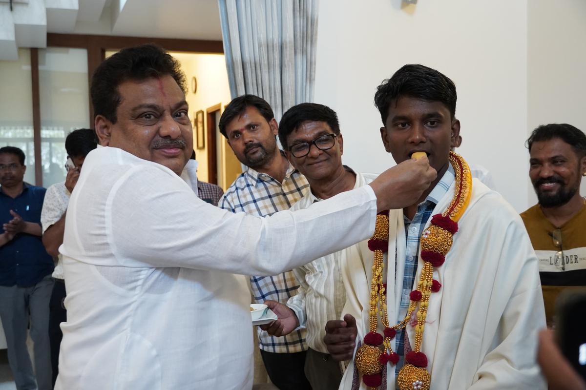 Minister and BLDE chairman M.B. Patil felicitating Vedant Navi, one of the Arts topper in Vijayapura on Wednesday. 