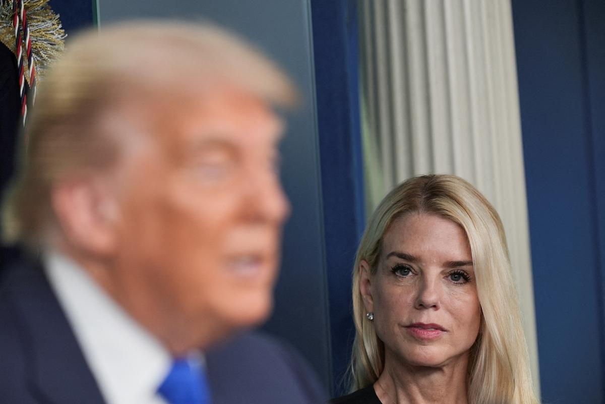U.S. Attorney General Pam Bondi listens as U.S. President Donald Trump speaks to the media. File