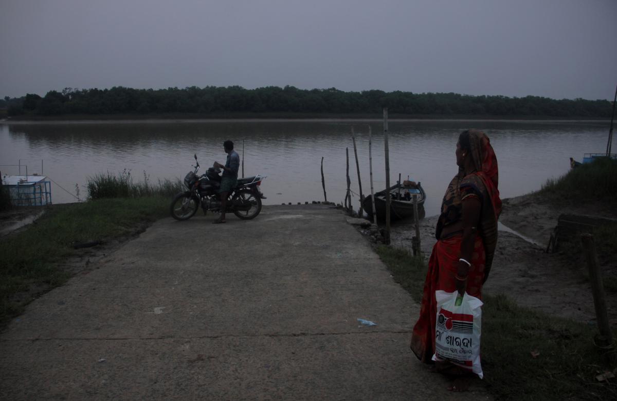 Villagers await a country boat to cross the Brahmani river near Gupti ghat inside the Bhitarkanika National Park in Odisha.