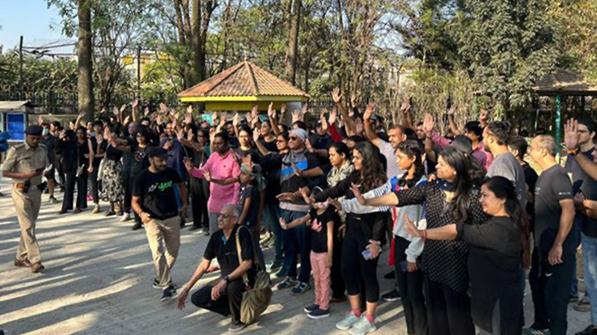 Citizens walk in black opposing Sankey flyover project