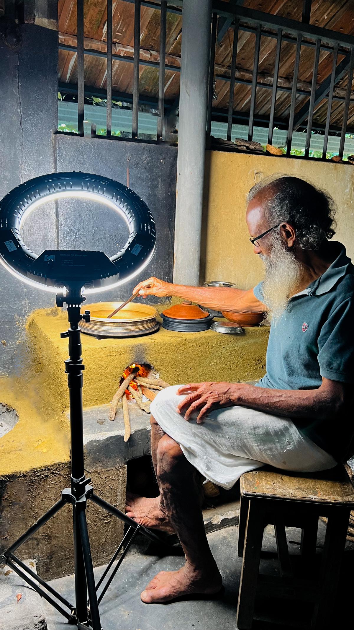 Gopalakrishnan cooking on the Nada chulah during the shoot for Dakshina
