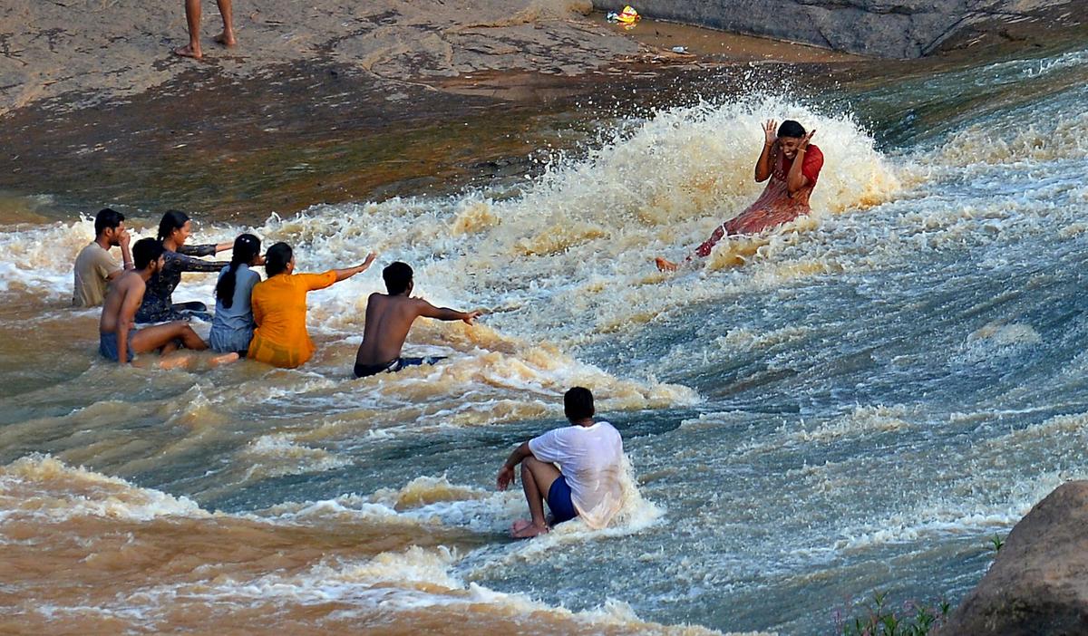 Youngsters enjoying a slide at Chapparai waterfalls near Araku.