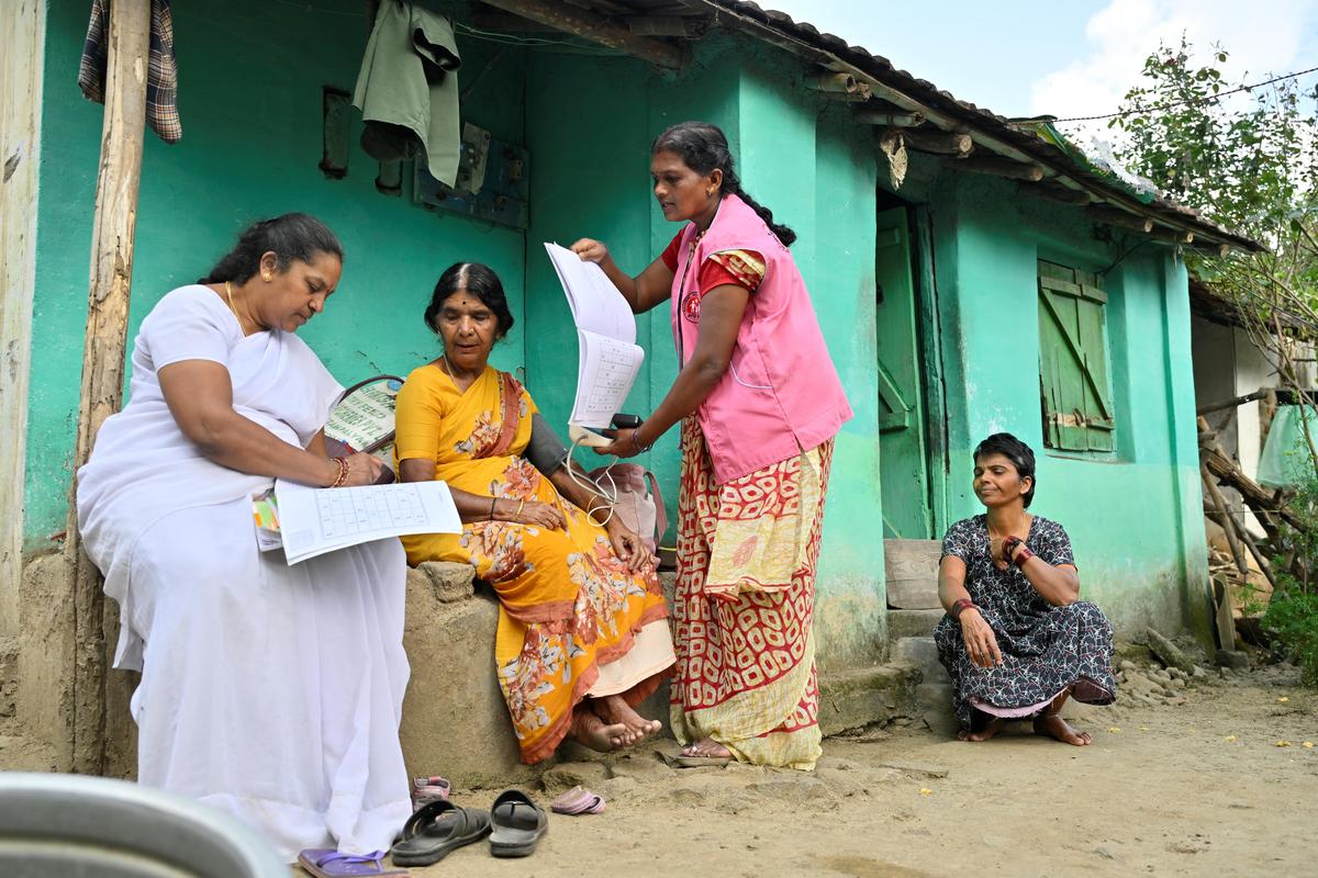A village health nurse collects data from tribal women near Mudumalai Tiger Reserve