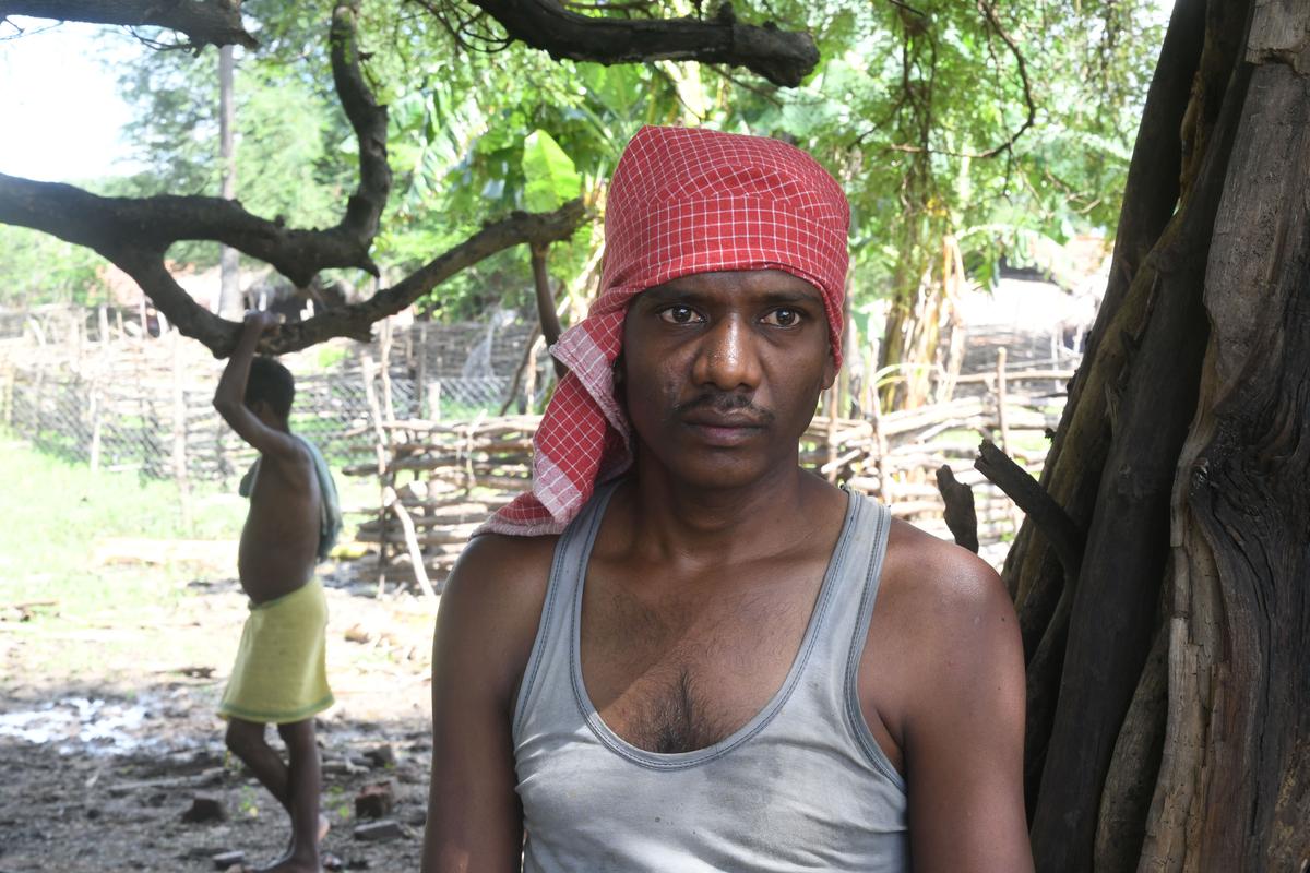 Caught unawares: Thirty-year-old Kawasi Kosa says he was sleeping on a cot outside his hut when a large group of policemen gathered around him and dragged him to the Kotwali police station in Sukma.