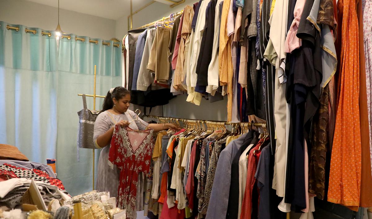 Sara, Store Manager of Zipline displays the thrift clothes in the store at Casa Major Road on Wednesday. 