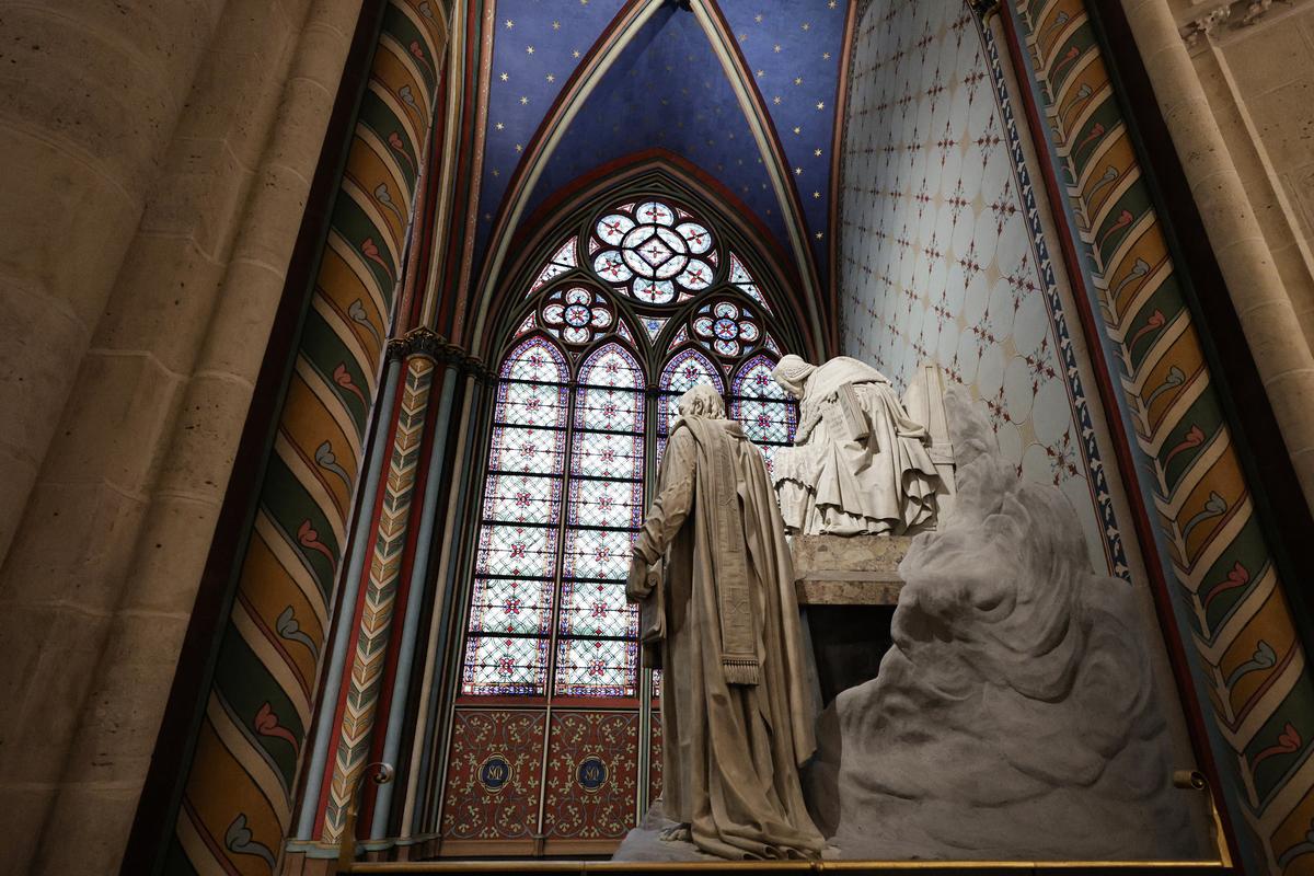 A statue is seen inside Notre-Dame de Paris cathedral while French President Emmanuel Macron visits the restored interiors of the monument
